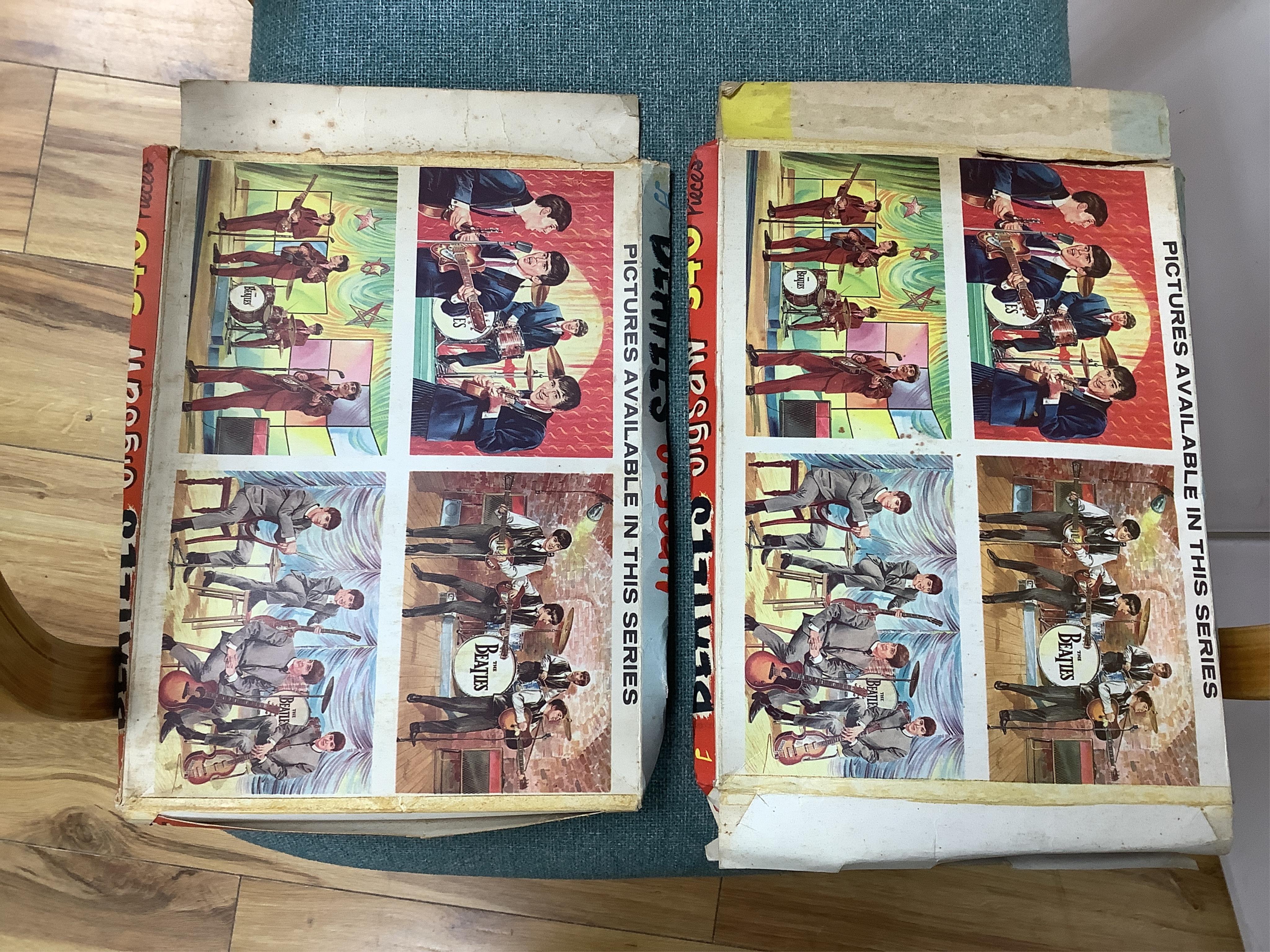 A 1960's Beatles child's plastic drum set in the original card box comprising of a snare drum on a stand, a card cut out bust of Ringo Starr, two 1960s Beatles jigsaws (unchecked) and a Beatles inflatable ball